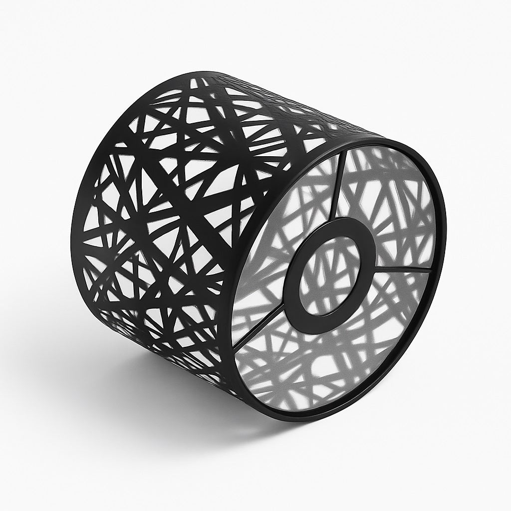 Abat-jour cylindrique noir à motif graphique ajouré, vue en perspective couché au sol – design moderne et lumineux