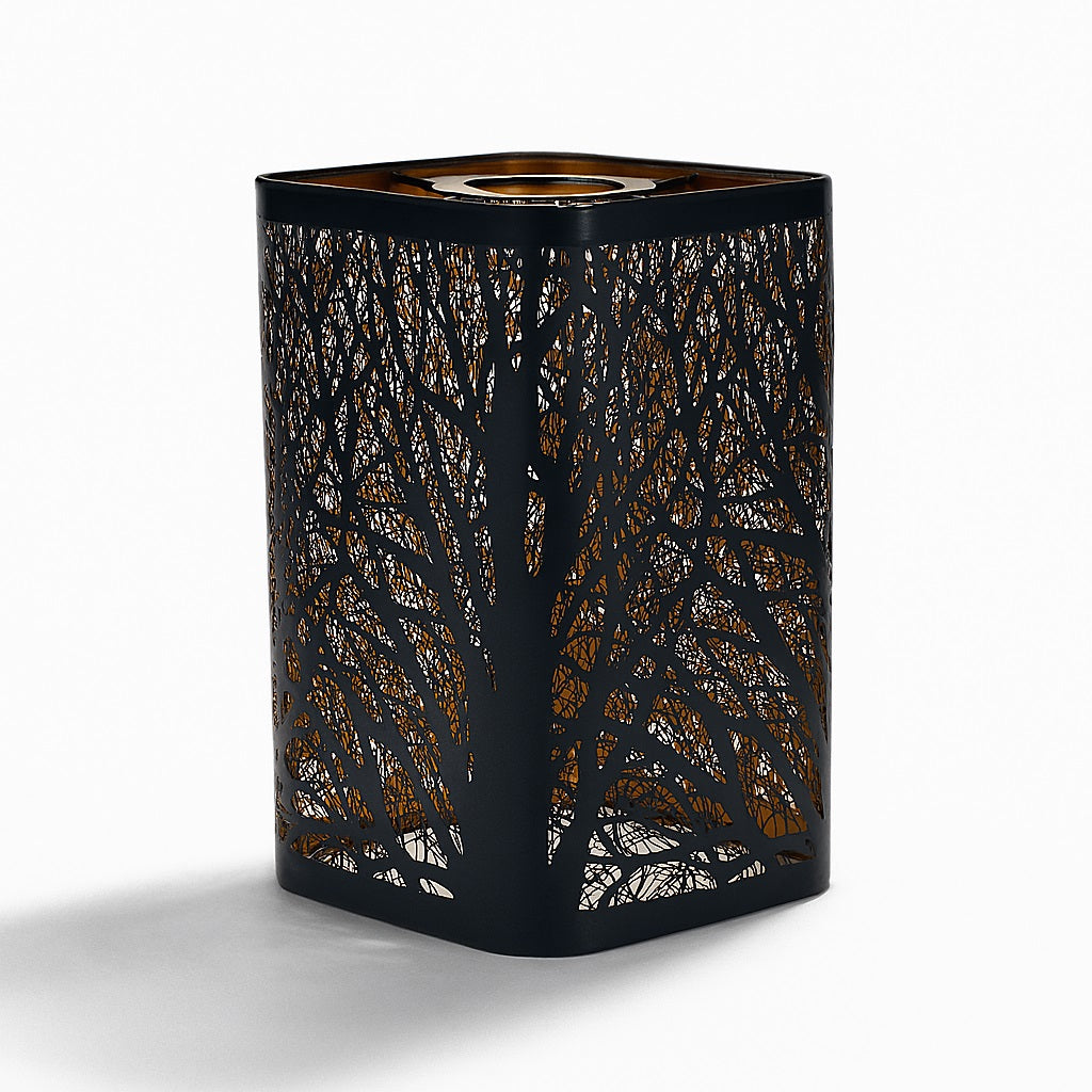 Abat-jour en métal noir ajouré avec motif de branches, effet forêt. Lumière tamisée pour une ambiance naturelle et chaleureuse.