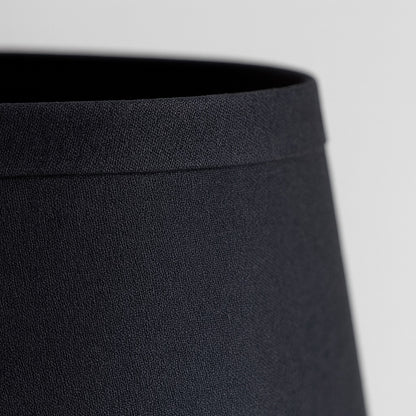 Zoom tissu noir d’un abat-jour conique, abat-jour lampe de chevet élégant au rendu moderne et raffiné.