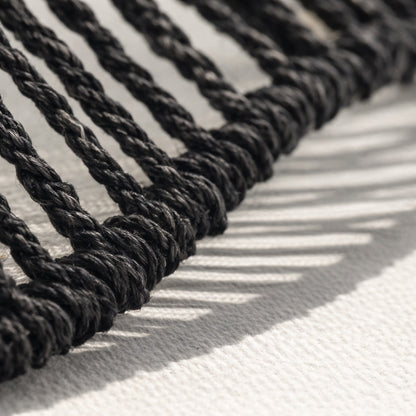 Gros plan sur le tressage d’un abat-jour suspension en corde noire, finition artisanale et texture naturelle.