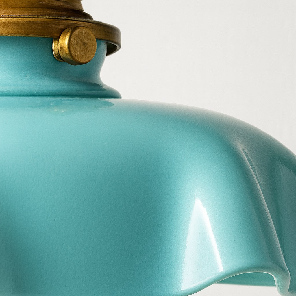 Zoom sur la surface brillante de la suspension Avara, finition turquoise lustrée et détails dorés raffinés.