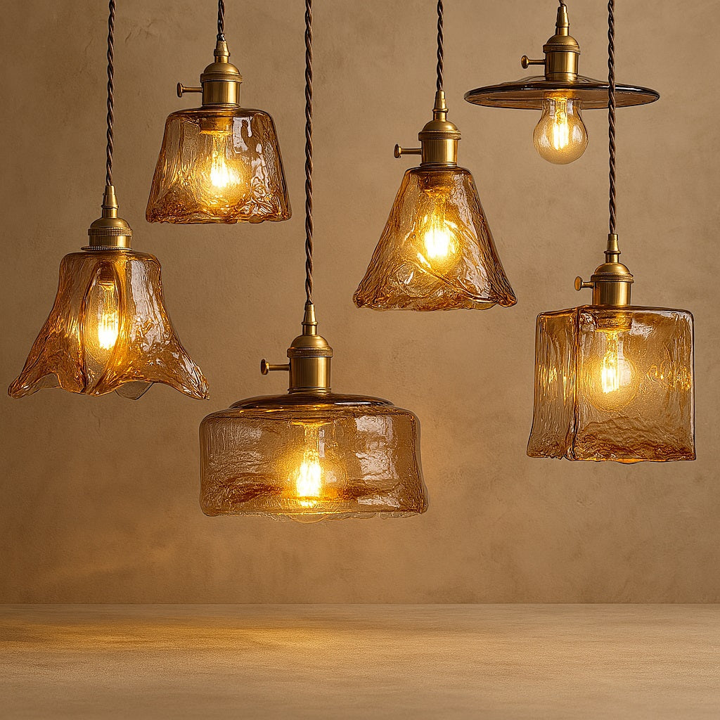 Suspensions en verre soufflé ambre aux formes variées, avec douille en laiton, lumière chaude et style vintage.
