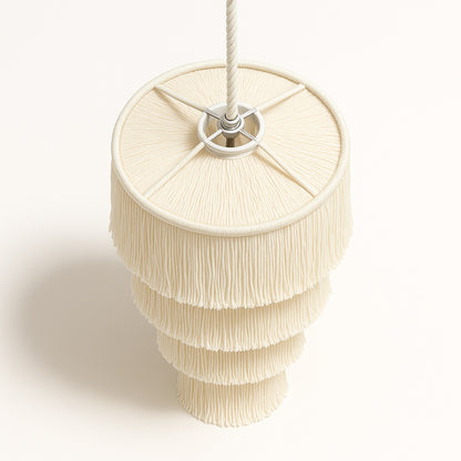 Abat-jour blanc Lumae en coton naturel vu du dessus, structure cylindrique à franges en cascade raffinée.