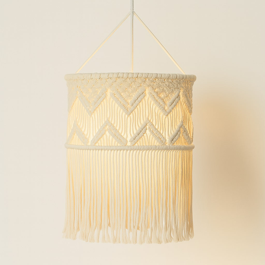 Suspension blanche en coton tressé macramé allumée, ombre douce sur fond clair, style bohème et moderne.