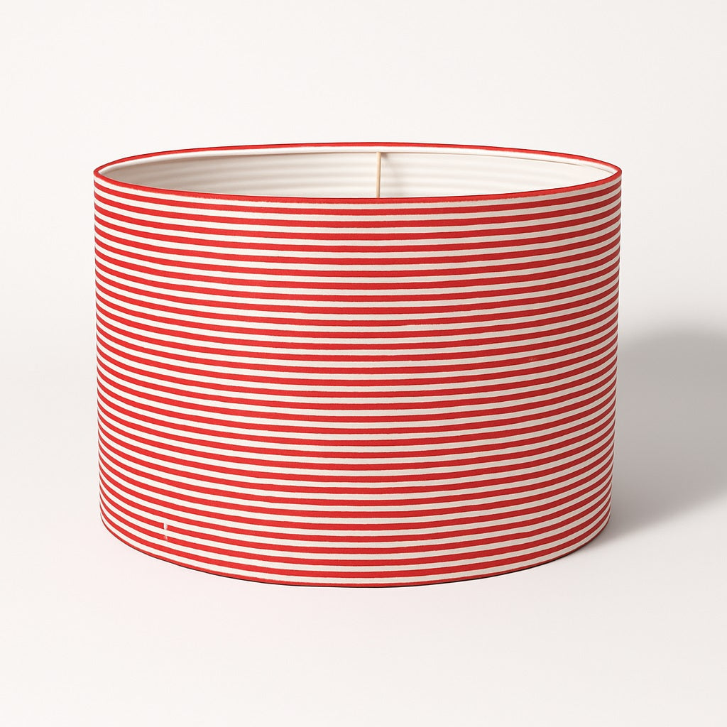 Abat-jour cylindrique rayé rouge et blanc sur fond blanc, parfait pour lampe de salon ou lampadaire.